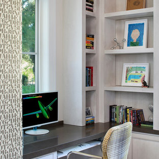 Large transitional home office in San Francisco with white walls, a built-in desk and cork floors.