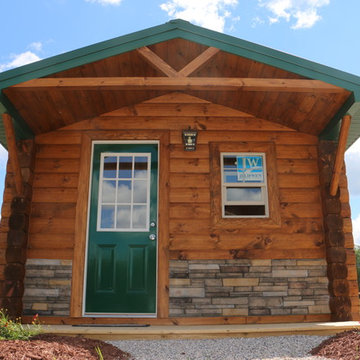 Tiny cabin with log siding and stonework
