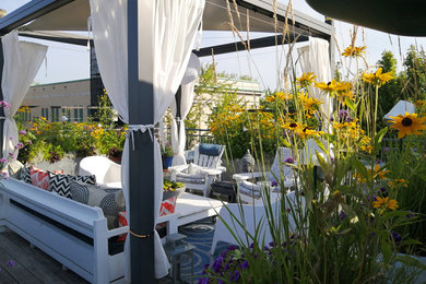 Small trendy rooftop rooftop metal railing deck container garden photo in Montreal with a pergola