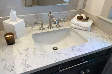 Example of a classic master ceramic tile porcelain tile and single-sink freestanding bathtub design in Boston with shaker cabinets, gray cabinets, a two-piece toilet, an undermount sink, quartz countertops, a hinged shower door and a built-in vanity