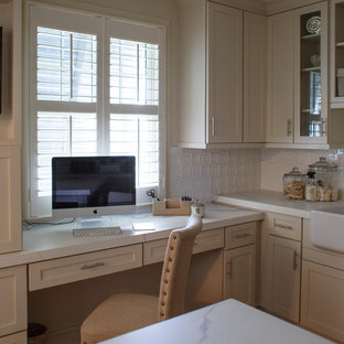 Large beach style craft room in Jacksonville with white walls, terra-cotta floors, a built-in desk and red floor.