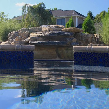Custom Freeform style salt water in ground pool with Pool House and Raised Spa