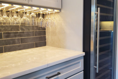 Example of a transitional home bar design in Atlanta with shaker cabinets and gray cabinets