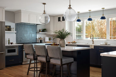 Large transitional u-shaped medium tone wood floor and brown floor open concept kitchen photo in Other with a single-bowl sink, shaker cabinets, blue cabinets, quartz countertops, blue backsplash, quartz backsplash, stainless steel appliances, an island and blue countertops