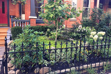 Inspiration for a small victorian partial sun front yard stone landscaping in Toronto for summer.