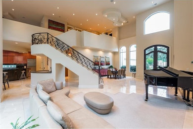 Example of a large transitional loft-style travertine floor and beige floor living room design in Atlanta with a music area, beige walls, a standard fireplace, a stone fireplace and no tv