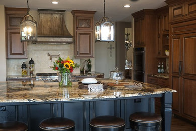 Example of a large classic u-shaped dark wood floor open concept kitchen design in Denver with a single-bowl sink, beaded inset cabinets, medium tone wood cabinets, granite countertops, beige backsplash, stone tile backsplash, paneled appliances and an island