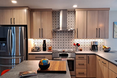 Example of a mid-sized trendy l-shaped light wood floor and multicolored floor eat-in kitchen design in Denver with a single-bowl sink, flat-panel cabinets, light wood cabinets, quartz countertops, multicolored backsplash, ceramic backsplash, stainless steel appliances, an island and multicolored countertops