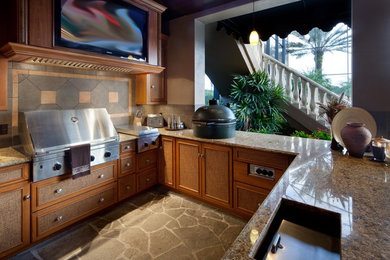 Mid-sized zen u-shaped concrete floor eat-in kitchen photo in Orlando with beaded inset cabinets, light wood cabinets, granite countertops, stone tile backsplash, stainless steel appliances and no island