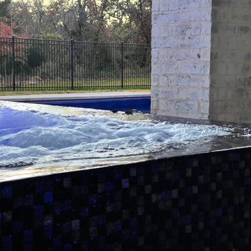 Polymer vinyl liner pool w/concrete spillover spa & automatic pool cover