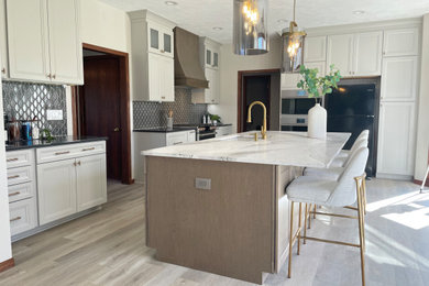 Inspiration for a huge transitional l-shaped vinyl floor and brown floor open concept kitchen remodel in Omaha with recessed-panel cabinets, gray cabinets, quartz countertops, gray backsplash, ceramic backsplash, stainless steel appliances and an island