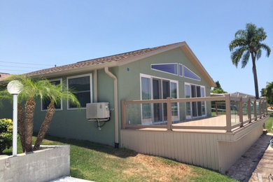 Mid-sized mountain style green one-story stucco gable roof photo in Tampa