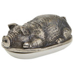Indigo Retreat - Babe Butter Dish - Keep your butter fresh and soft with the Pigsley Butter Dish. Crafted from porcelain and featuring an impressive metal pig topper, this piece provides all the function of a butter dish while also giving your kitchen space an attractive piece of decor to display on your counter. Measures at 7 inches long, 4.25 inches wide and 3.5 inches high.