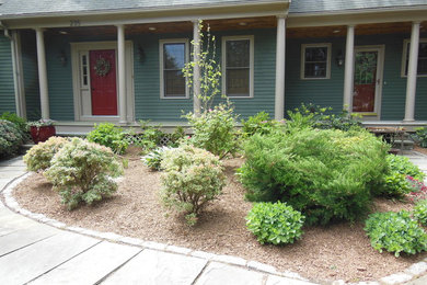 This is an example of a large traditional partial sun front yard concrete paver landscaping in Boston.
