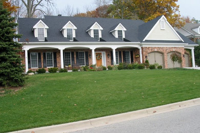 Example of a mid-sized farmhouse one-story exterior home design in Other