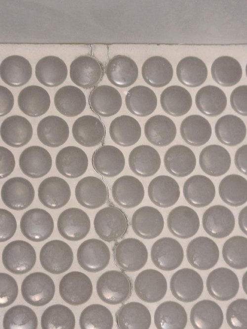 Penny tile shower floor grout is cracking. Normal?