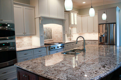 Kitchen - huge dark wood floor kitchen idea in Raleigh with an undermount sink, flat-panel cabinets, white cabinets, granite countertops, multicolored backsplash, porcelain backsplash, stainless steel appliances and an island