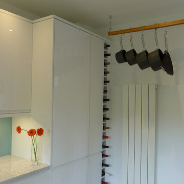 white gloss modern kitchen with tall wine rack