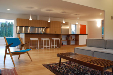 Example of a large minimalist galley light wood floor and beige floor open concept kitchen design in New York with an undermount sink, flat-panel cabinets, medium tone wood cabinets, quartz countertops, metallic backsplash, stainless steel appliances and an island