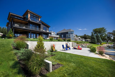 Inspiration for a contemporary drought-tolerant and full sun backyard concrete paver retaining wall landscape in Jackson for summer.
