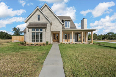 Rustic gray two-story stone house exterior idea in Dallas with a gray roof