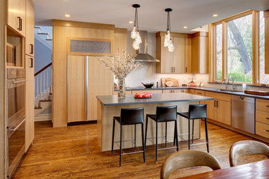 Eat-in kitchen - large modern medium tone wood floor and brown floor eat-in kitchen idea in New York with a single-bowl sink, flat-panel cabinets, light wood cabinets, quartz countertops, white backsplash, ceramic backsplash, paneled appliances, an island and gray countertops