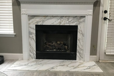 Example of a trendy family room design in Charleston with a stone fireplace