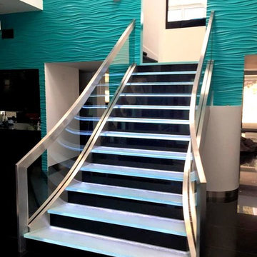 Stainless Staircase with bent glass and LED backlit glass steps