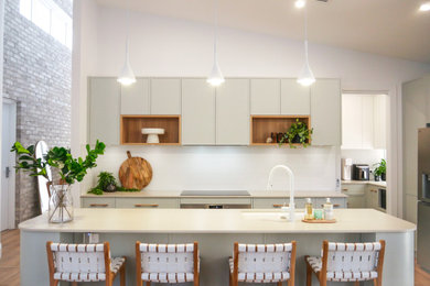 Inspiration for a modern kitchen in Sydney with an undermount sink, green cabinets, quartz benchtops, white splashback, subway tile splashback and white benchtop.