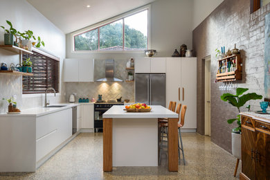 Example of a large trendy l-shaped open concept kitchen design in Newcastle - Maitland with an undermount sink, flat-panel cabinets, white cabinets, gray backsplash, mosaic tile backsplash, stainless steel appliances, an island and white countertops