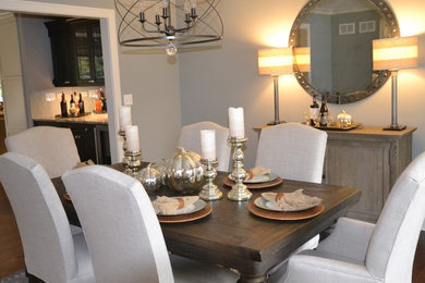 Example of a mid-sized transitional medium tone wood floor great room design in Chicago with gray walls
