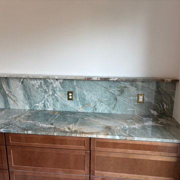 Green quartzite kitchen with full-height slab backsplash