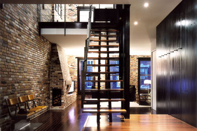 Design ideas for a wood straight staircase in New York with open risers.