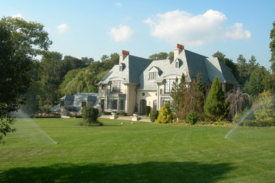 Inspiration for a large timeless beige three-story stone gable roof remodel in Bridgeport