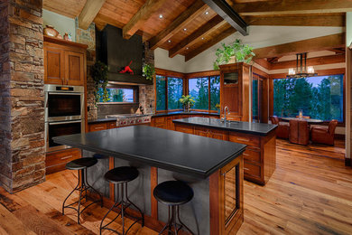 Eat-in kitchen - large rustic l-shaped light wood floor eat-in kitchen idea in Other with an undermount sink, raised-panel cabinets, light wood cabinets, multicolored backsplash, stainless steel appliances and two islands