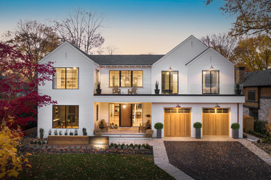 Large modern white two-story house exterior idea in Toronto with a gray roof
