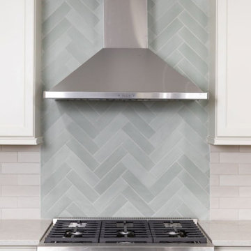Herringbone Tile Backsplash with Stainless Steel Range Hood