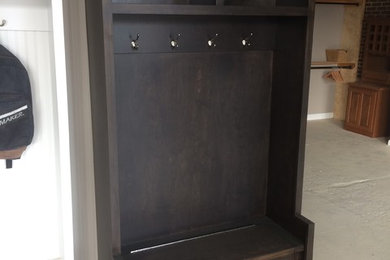 Mid-sized elegant mudroom photo in Chicago with a dark wood front door
