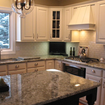 Medium color wood to off white with white subway tile and granite counter tops
