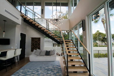 Example of a large trendy u-shaped light wood floor seated home bar design in Orlando with an undermount sink, dark wood cabinets and onyx countertops