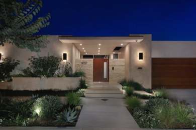 Inspiration for a large modern beige one-story glass flat roof remodel in Orange County with a mixed material roof