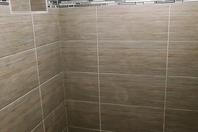 Imagen de cuarto de baño minimalista de tamaño medio con baldosas y/o azulejos negros, baldosas y/o azulejos de porcelana, suelo de baldosas de porcelana y suelo marrón