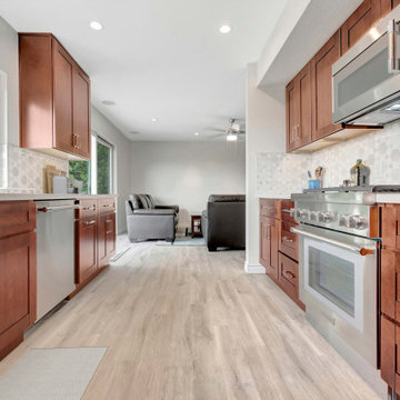 Transitional Galley Kitchen Remodel with Rich Wood Cabinetry and Open Living Flo