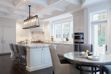 Large traditional l-shaped eat-in kitchen in Boston with white cabinets, granite benchtops, grey splashback, ceramic splashback, stainless steel appliances, dark hardwood floors, with island and brown floor.