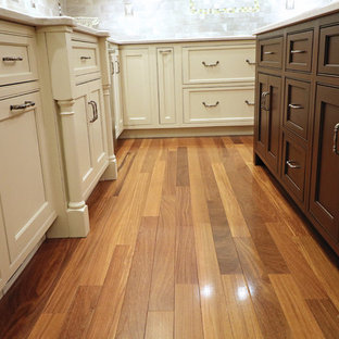 Large transitional u-shaped kitchen pantry in Boston with an undermount sink, beaded inset cabinets, white cabinets, quartz benchtops, grey splashback, ceramic splashback, stainless steel appliances, dark hardwood floors, with island and red floor.