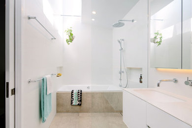 Contemporary 3/4 wet room bathroom in Melbourne with flat-panel cabinets, white cabinets, a drop-in tub, white walls, an undermount sink, beige floor and an open shower.