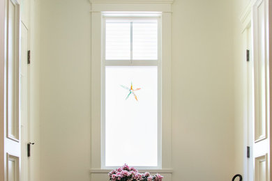 Inspiration for a timeless mudroom remodel in Vancouver with white walls
