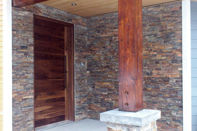 Inspiration for a large contemporary entryway remodel in Vancouver with a dark wood front door