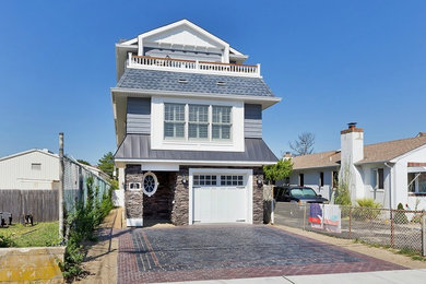 Mid-sized beach style three-storey blue exterior in New York with mixed siding and a gable roof.