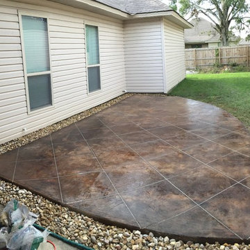 Concrete patio acid stained , scored in tile pattern